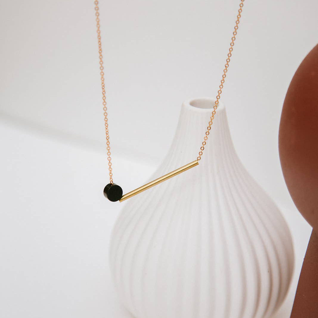 Copper Bee black and brass geometric necklace with polished brass bar and oxidised black disc