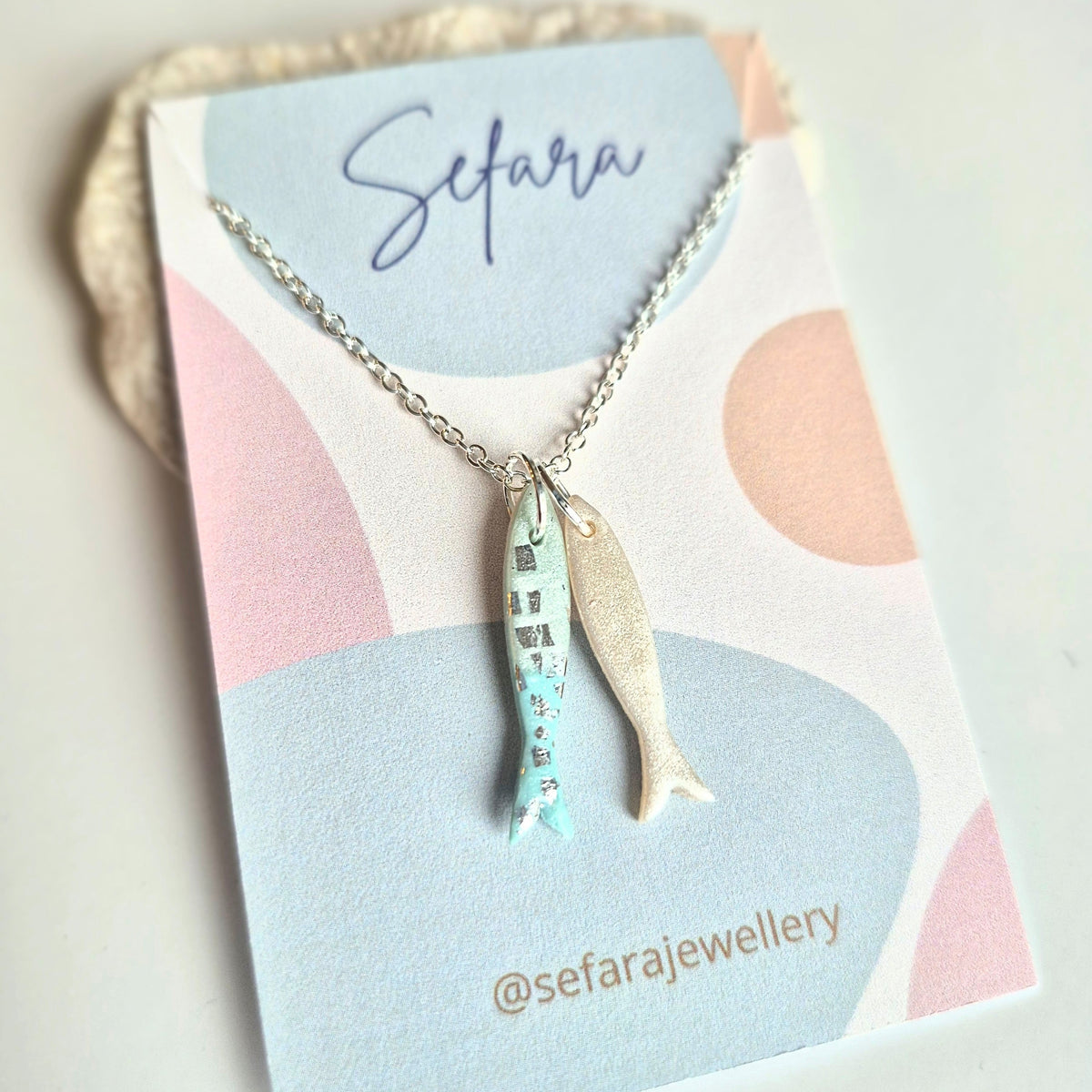 Sefara Jewellery handmade polymer clay sardines pendant necklaces in blue shades, available with two or three sardines on 18-inch silver-plated chains.