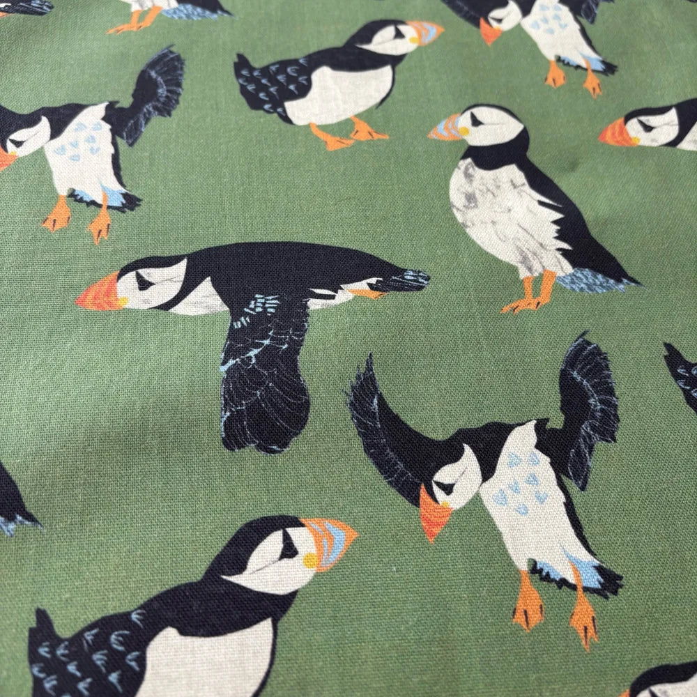 Pattern of puffins on a green background