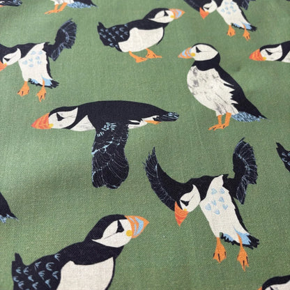 Pattern of puffins on a green background