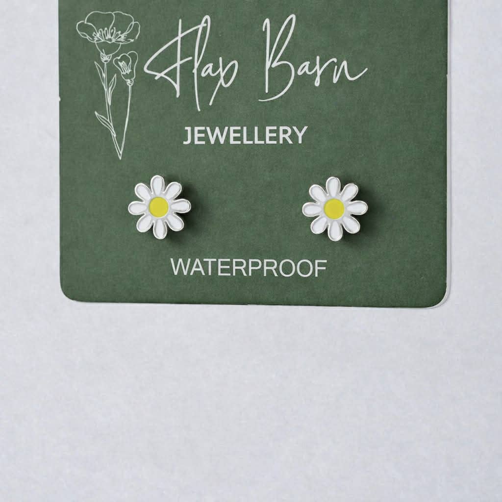 Flax Barn enamel flower stud earrings in tarnish resistant PVD-plated stainless steel on a display card