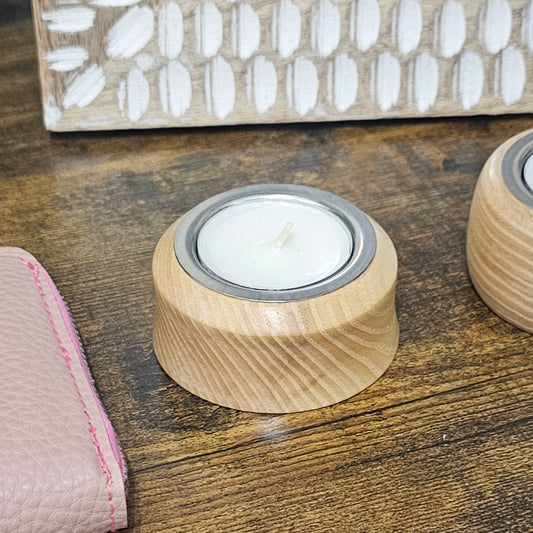 Handmade circular reclaimed wood tealight holders in extra short, short, medium and tall sizes, with natural wood grain and rustic finishes.