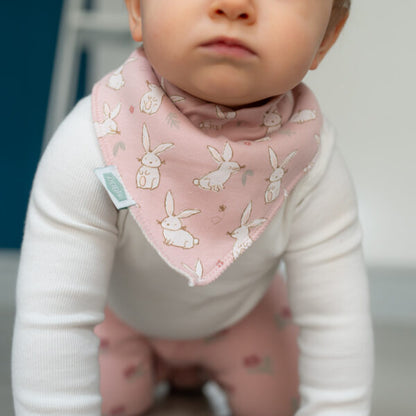 Soft pink baby bandana bib with bunny print, absorbent fleece backing and adjustable poppers