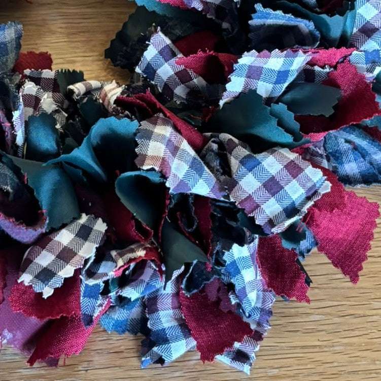 Christmas wreath made using strips of recycled fabric for a festive wreath-making workshop at HAYM in Carnoustie.