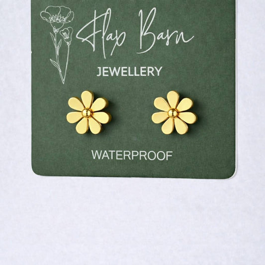 Flax Barn tarnish resistant flower stud earrings in PVD-plated stainless steel on a branded display card