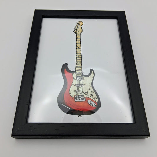 Bee Birds lino print picture of a red and white electric guitar in a small black frame