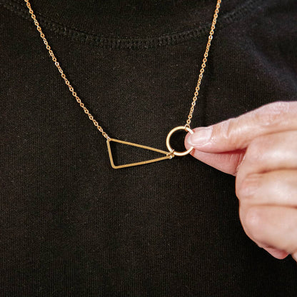 Copper Bee geometric necklace with polished brass circle and triangle shapes on a fine gold-plated chain