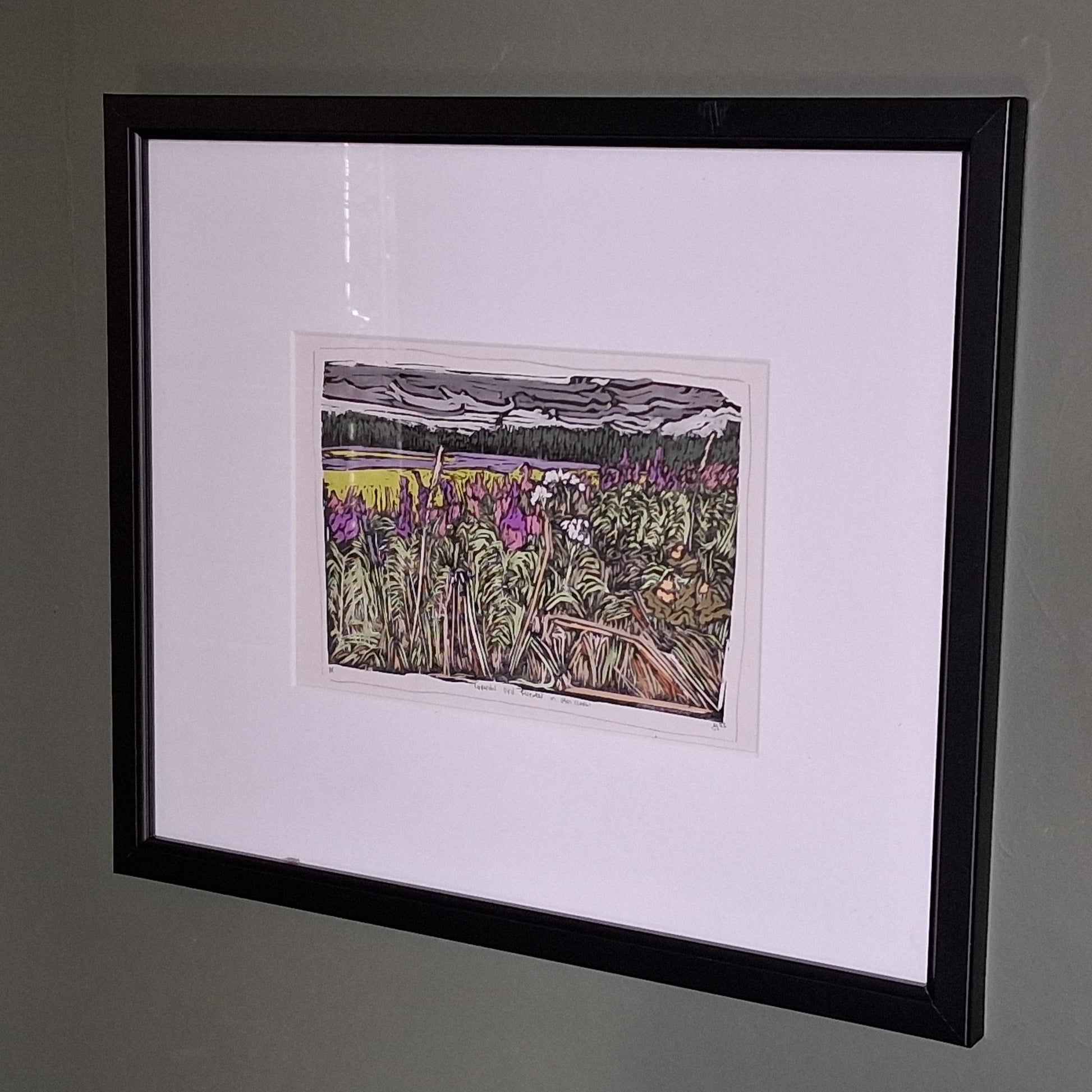 A colourful linocut print by BeeBirds depicting a scenic view of Glen Clova in Angus, highlighting lavender and fireweed, mounted in a black frame.