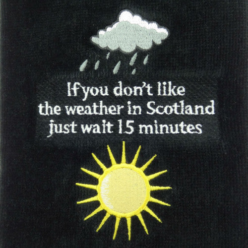 Black cotton velour Scottish golf towels with embroidered Scottish Weather and Golfing Life quotes, measuring 50 x 40cm with carabiner attachments.