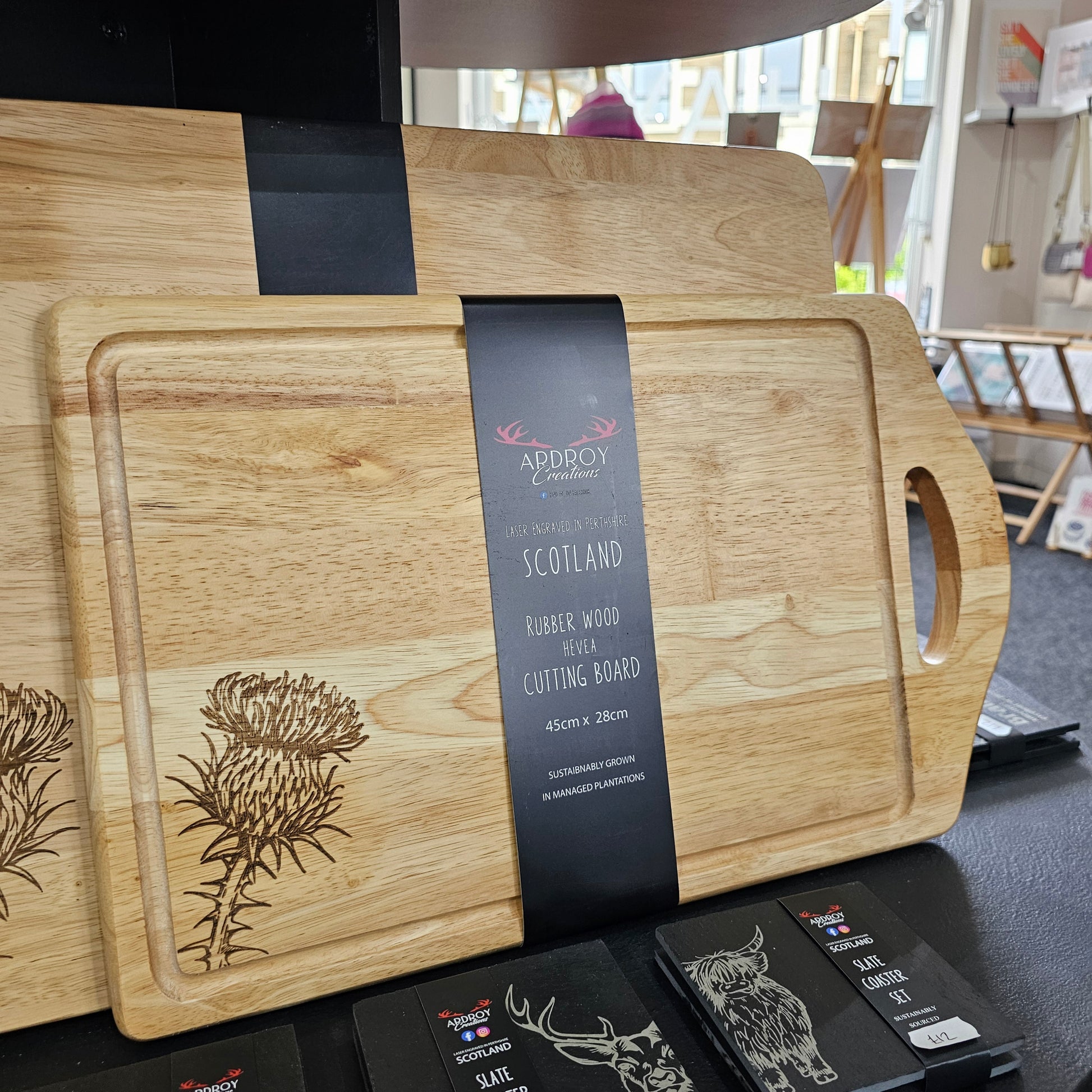 Scottish Hevea wood serving board by Ardroy Creations with cut-out handle and Thistle design