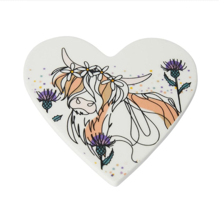 Heart-shaped white porcelain coaster featuring a hand-drawn Highland Cow illustration, presented in a gift box.
