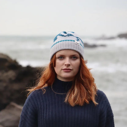 Close-up of a textured lambswool beanie hat, showing the quality of the knit and natural colourway, representing the weathered rocks and sand of the Scottish coast.