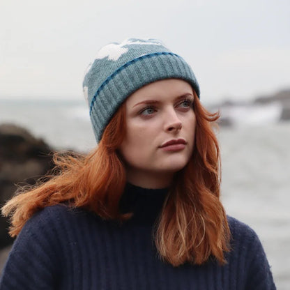 Close-up of a textured lambswool beanie hat, showing the quality of the knit and natural colourway, representing the weathered rocks and sand of the Scottish coast.