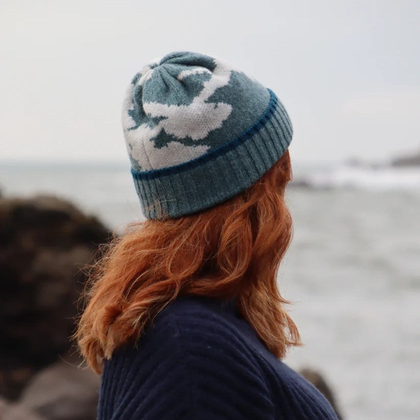 Close-up of a textured lambswool beanie hat, showing the quality of the knit and natural colourway, representing the weathered rocks and sand of the Scottish coast.