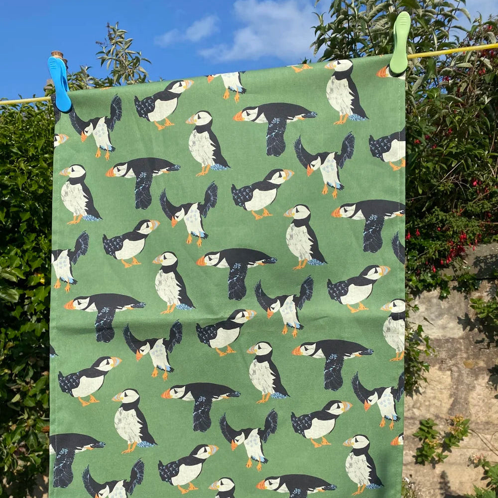 Towel with puffin pattern hanging outdoors on a clothesline