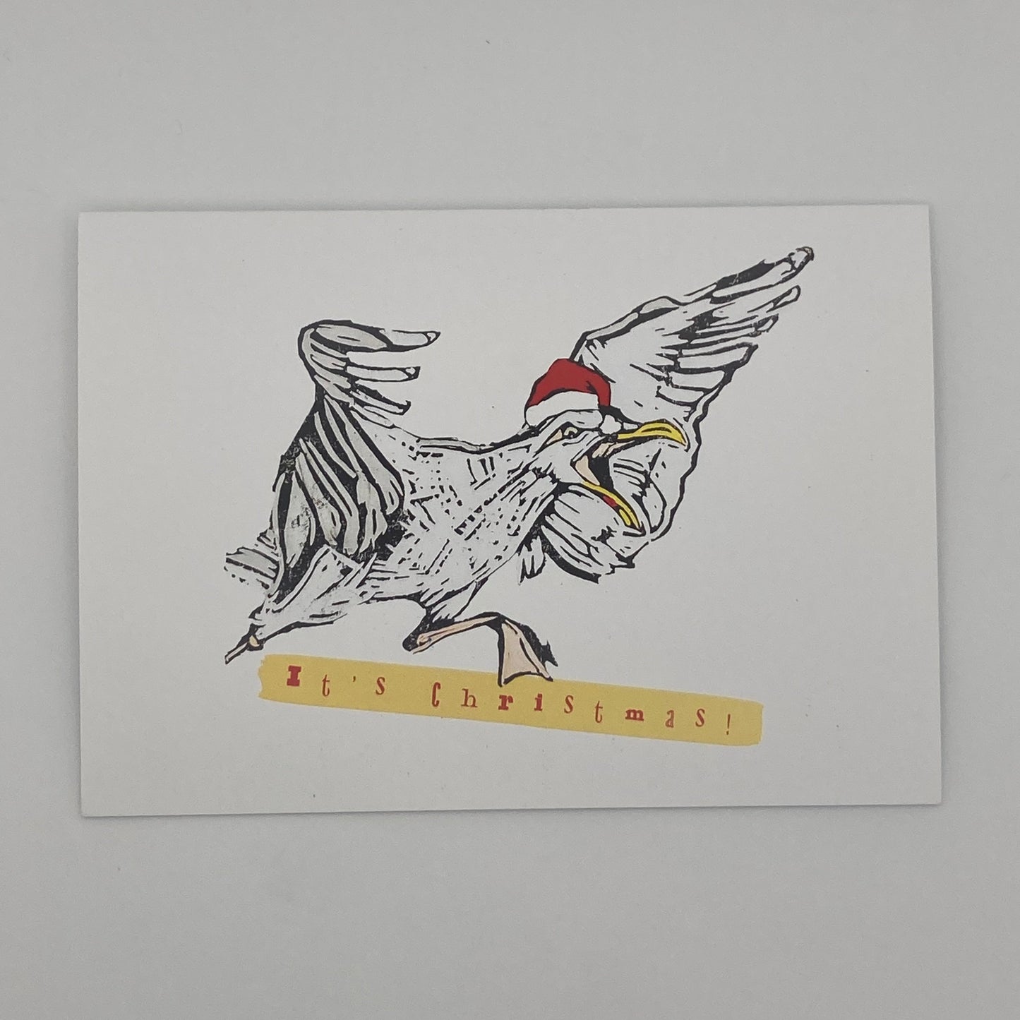 Seagull in a Santa hat with bold text “It’s Christmas”, bright festive BeeBirds card illustration.