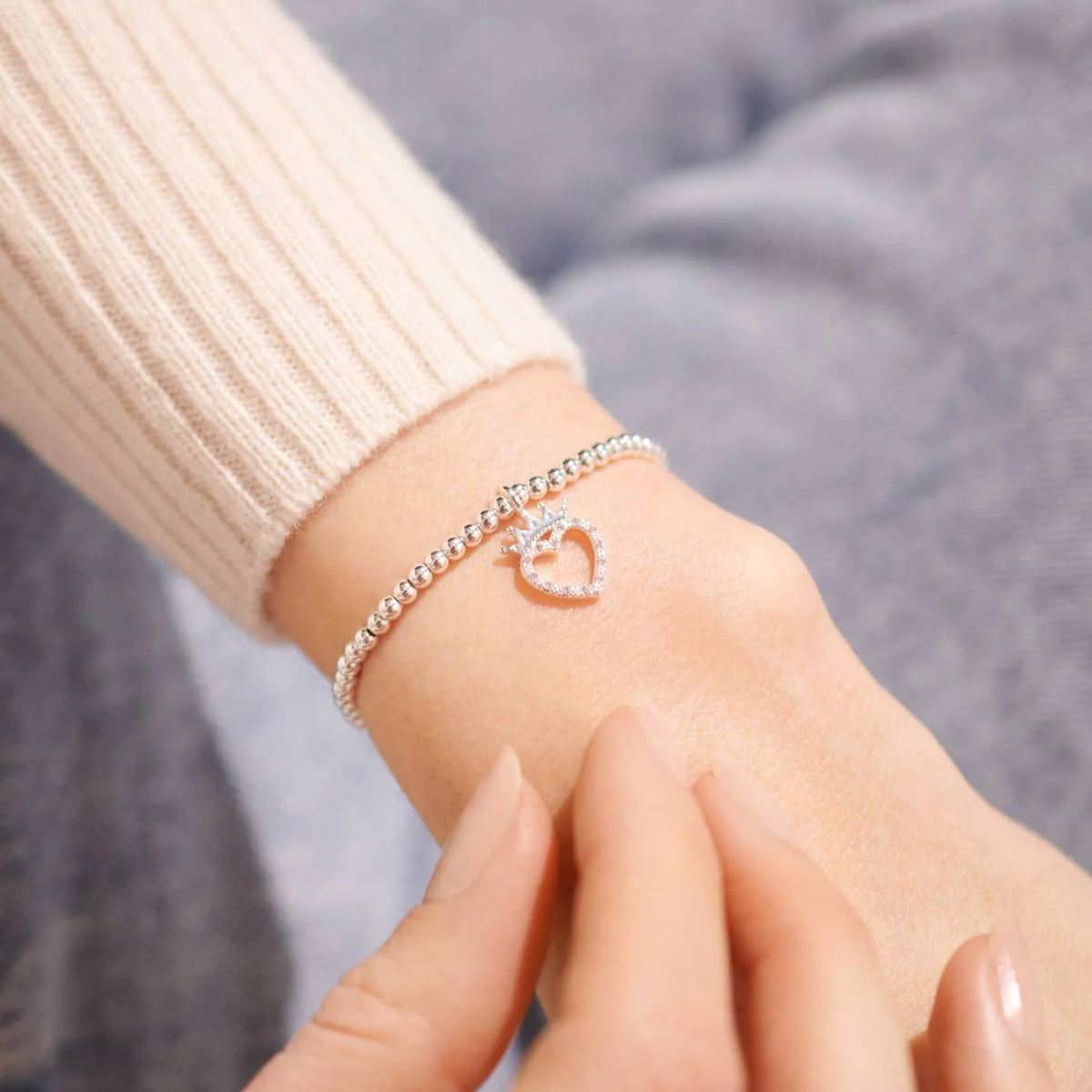 A silver Joma bracelet with a crowned heart charm, packaged in a card that reads 'A Little BIRTHDAY QUEEN'.