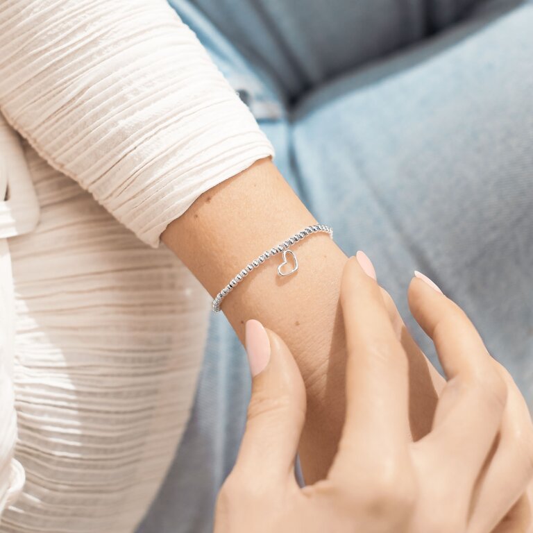 Silver plated 'Amazing Auntie' Joma Jewellery heart charm bracelet worn on wrist