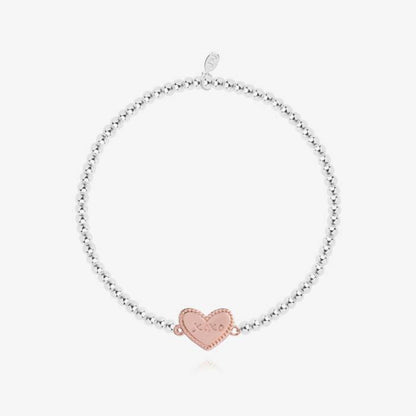 A silver plated stretch beaded bracelet with a rose-gold plated heart charm