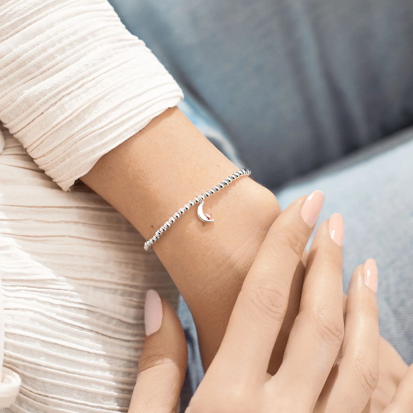 Silver plated 'Love You To The Moon and Back' Joma Jewellery bracelet shown on wrist