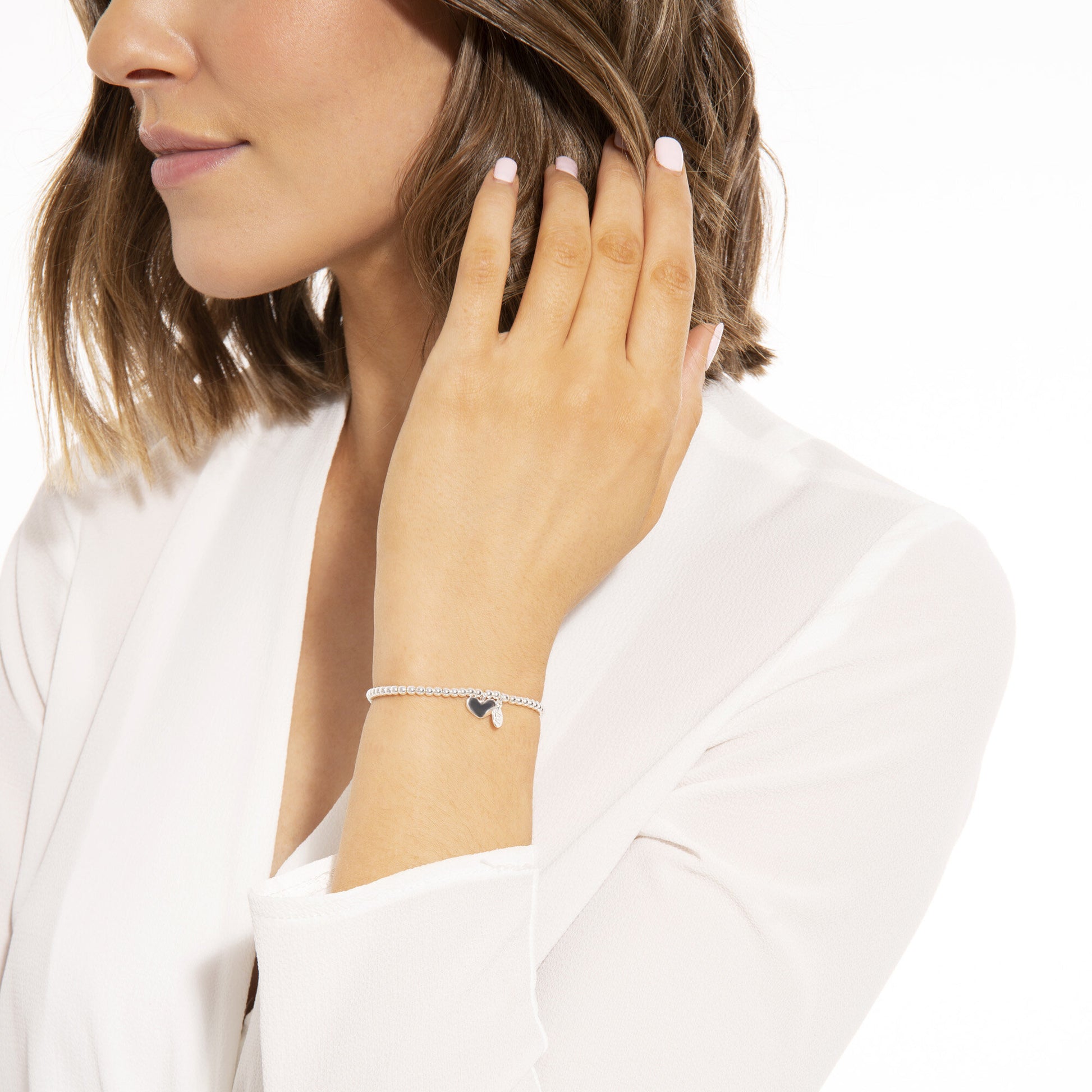 Silver plated 'Lovely Niece' Joma Jewellery heart charm bracelet worn on wrist