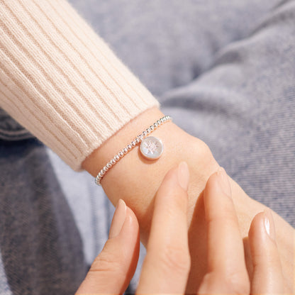 Joma A Little 'Safe Travels' silver plated stretch bracelet with compass charm shown on wrist