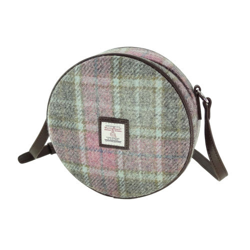 Classic compact round shoulder bag made from genuine Harris Tweed wool, featuring a zip closure, adjustable strap, and faux leather trim.