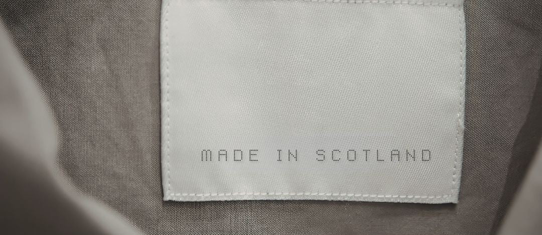 Label on fabric stating 'Made in Scotland' with a blurred background