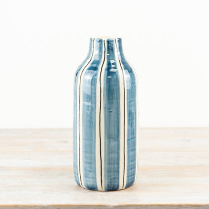 Blue and white striped ceramic decorative vase ideal for flowers or as a standalone statement piece in any home décor setting.
