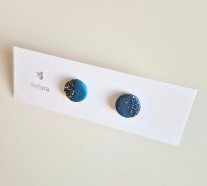 Blue and gold Sefara round stud earrings on a branded card
