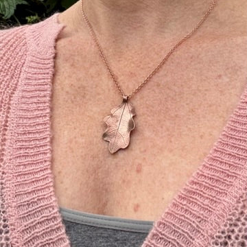 Rowan Berry Jewellery handcrafted copper oak leaf necklaces in three styles: simple leaf, sculptural statement leaf and oak leaf with sterling silver tiger's eye acorn.