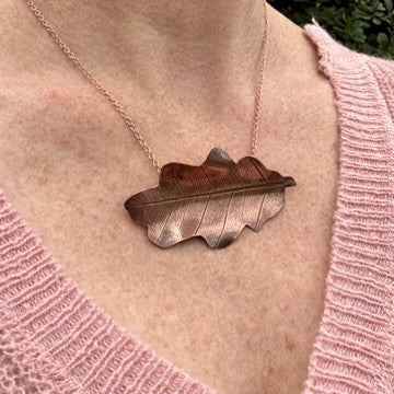 Rowan Berry Jewellery handcrafted copper oak leaf necklaces in three styles: simple leaf, sculptural statement leaf and oak leaf with sterling silver tiger's eye acorn.