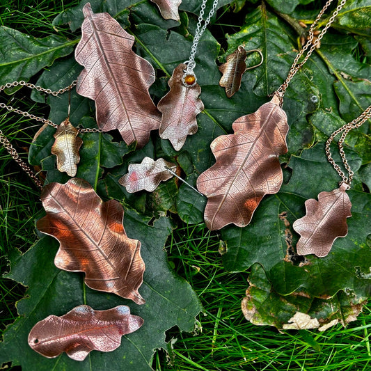 Rowan Berry Jewellery handcrafted copper oak leaf necklaces in three styles: simple leaf, sculptural statement leaf and oak leaf with sterling silver tiger's eye acorn.
