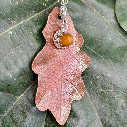 Rowan Berry Jewellery handcrafted copper oak leaf necklaces in three styles: simple leaf, sculptural statement leaf and oak leaf with sterling silver tiger's eye acorn.