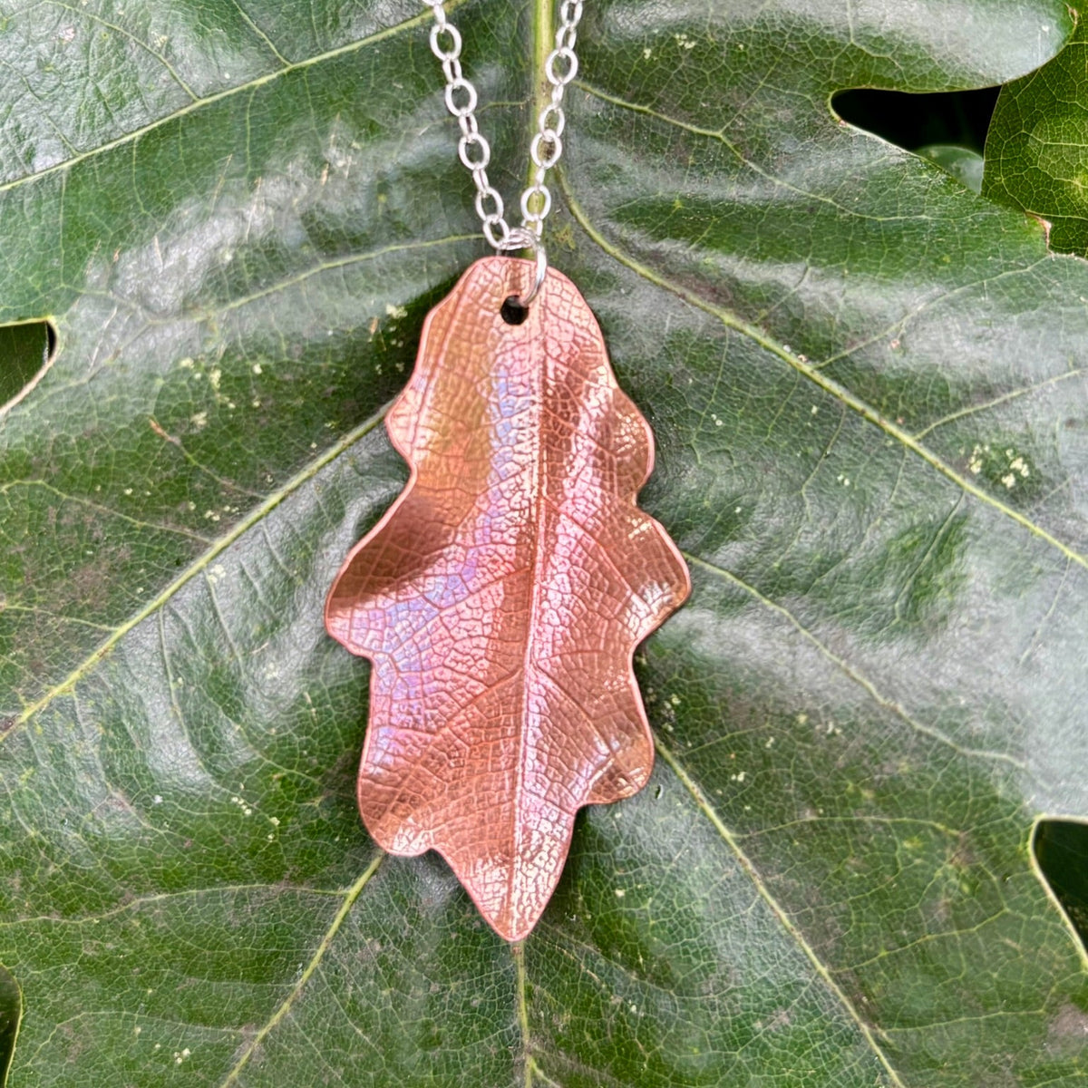 Rowan Berry Jewellery handcrafted copper oak leaf necklaces in three styles: simple leaf, sculptural statement leaf and oak leaf with sterling silver tiger's eye acorn.