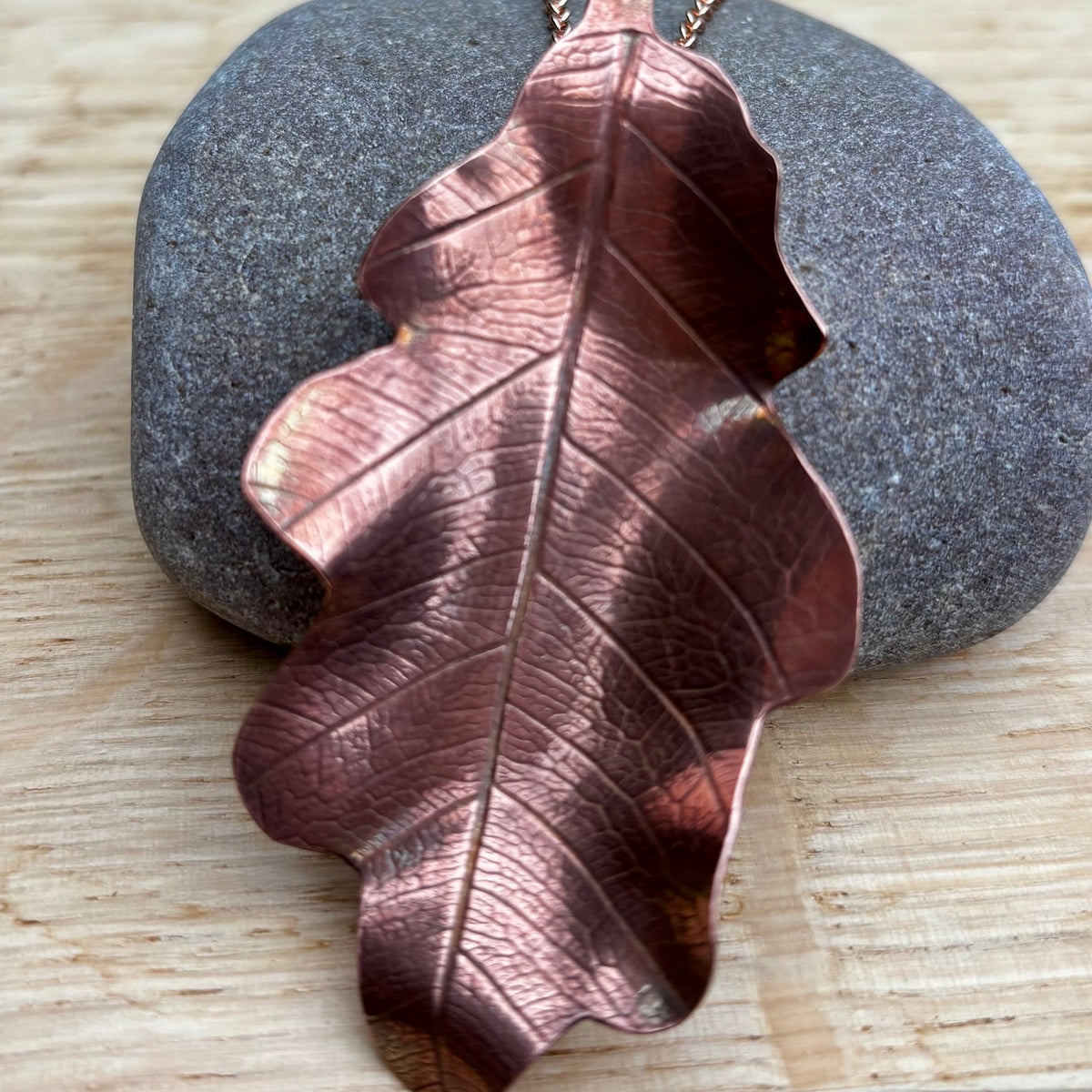 Rowan Berry Jewellery handcrafted copper oak leaf necklaces in three styles: simple leaf, sculptural statement leaf and oak leaf with sterling silver tiger's eye acorn.