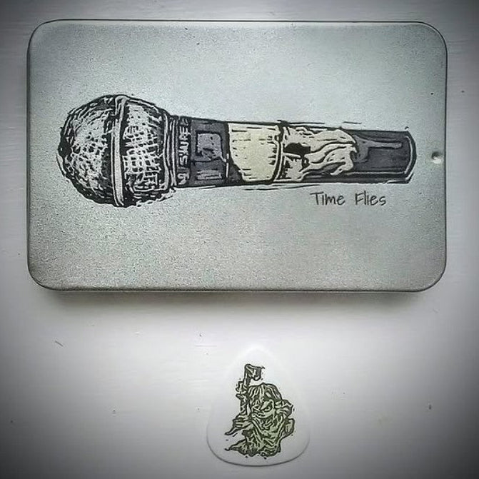 Silver tin with Microphone image and 'Time Flies' text on the sliding lid.