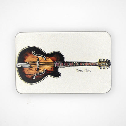 Silver rectangular tin with sliding lid featuring a guitar image with the phrase 'Time Flies' written on it.