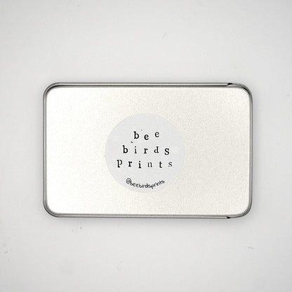Base of silver rectangular tin with Beebirds sticker