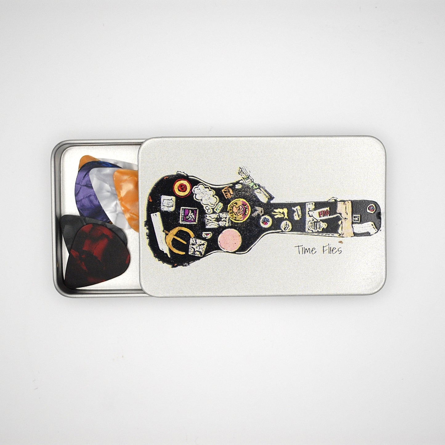 Silver rectangular tin with sliding lid featuring a guitar case image with the phrase 'Time Flies' written on it.