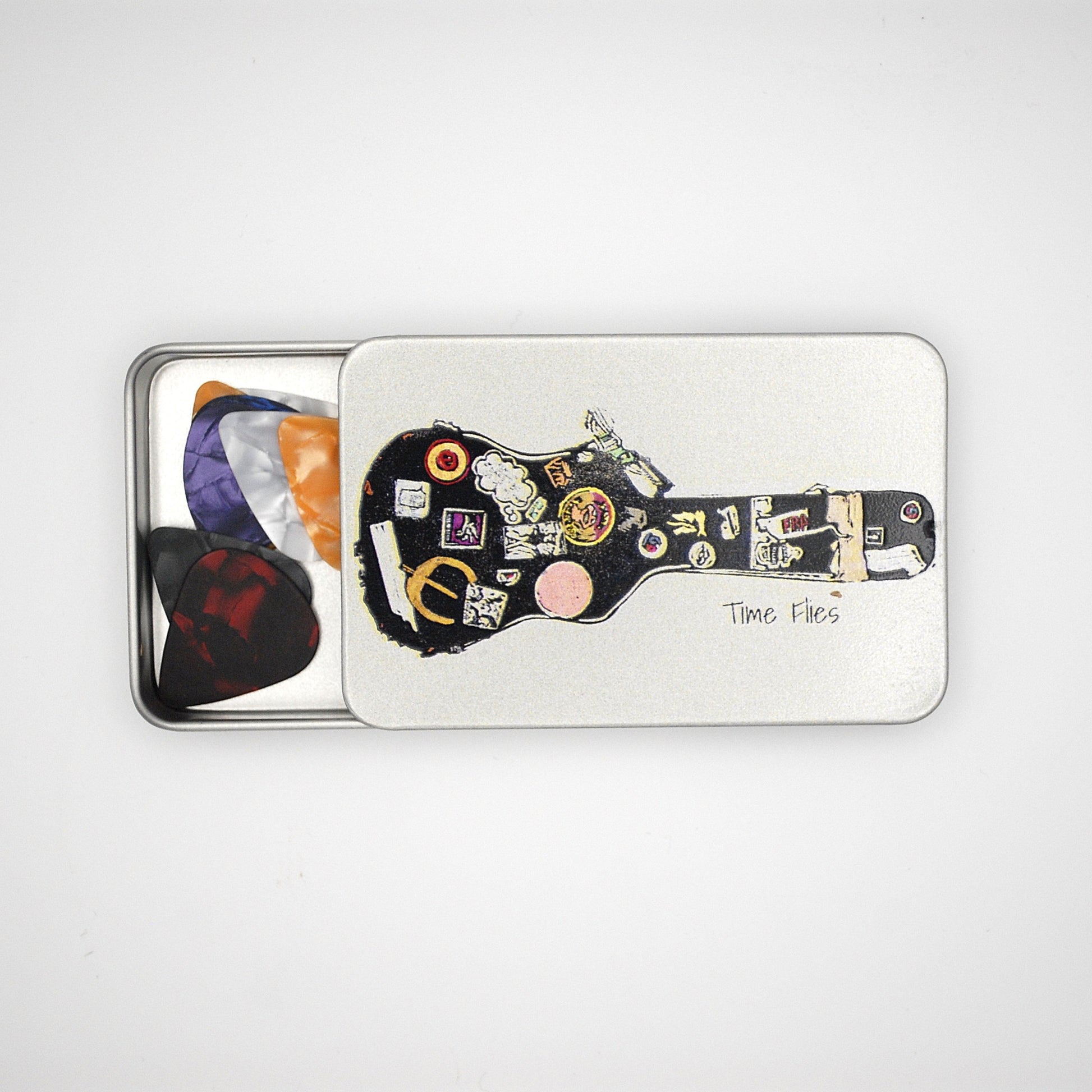 Silver rectangular tin with sliding lid featuring a guitar case image with the phrase 'Time Flies' written on it.
