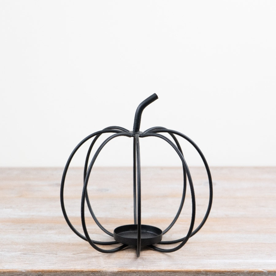 Dark metal open frame pumpkin tealight holder with sculptural curved design for autumn décor