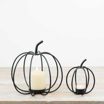 Dark metal open frame pumpkin tealight holders with sculptural curved design for autumn décor