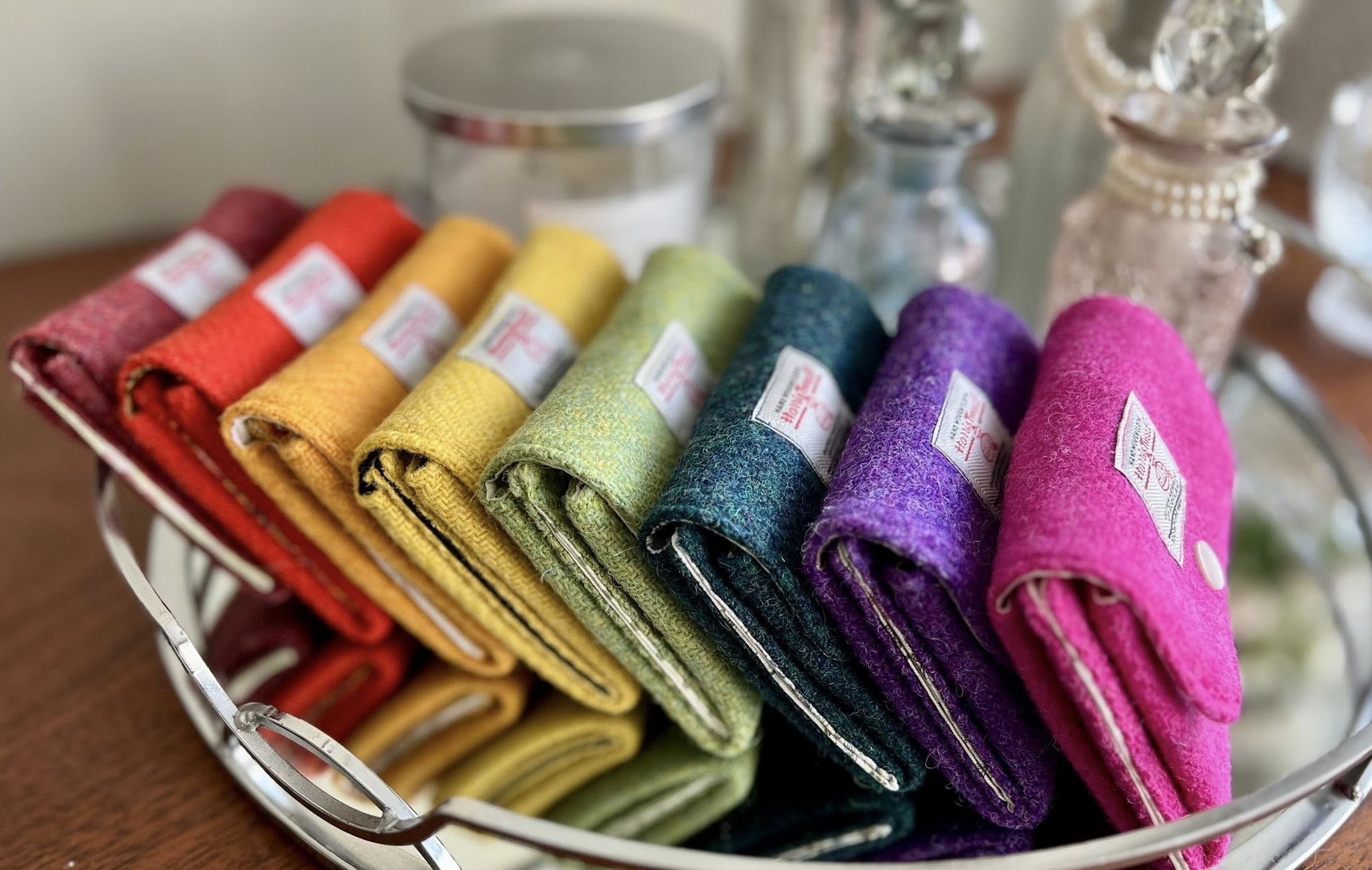 Set of colourful Harris Tweed coin purses displayed like a rainbow