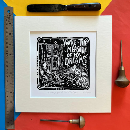 An original black and white linocut print featuring imagery inspired by The Pogues song 'A Rainy Night in Soho', mounted on antique white card.