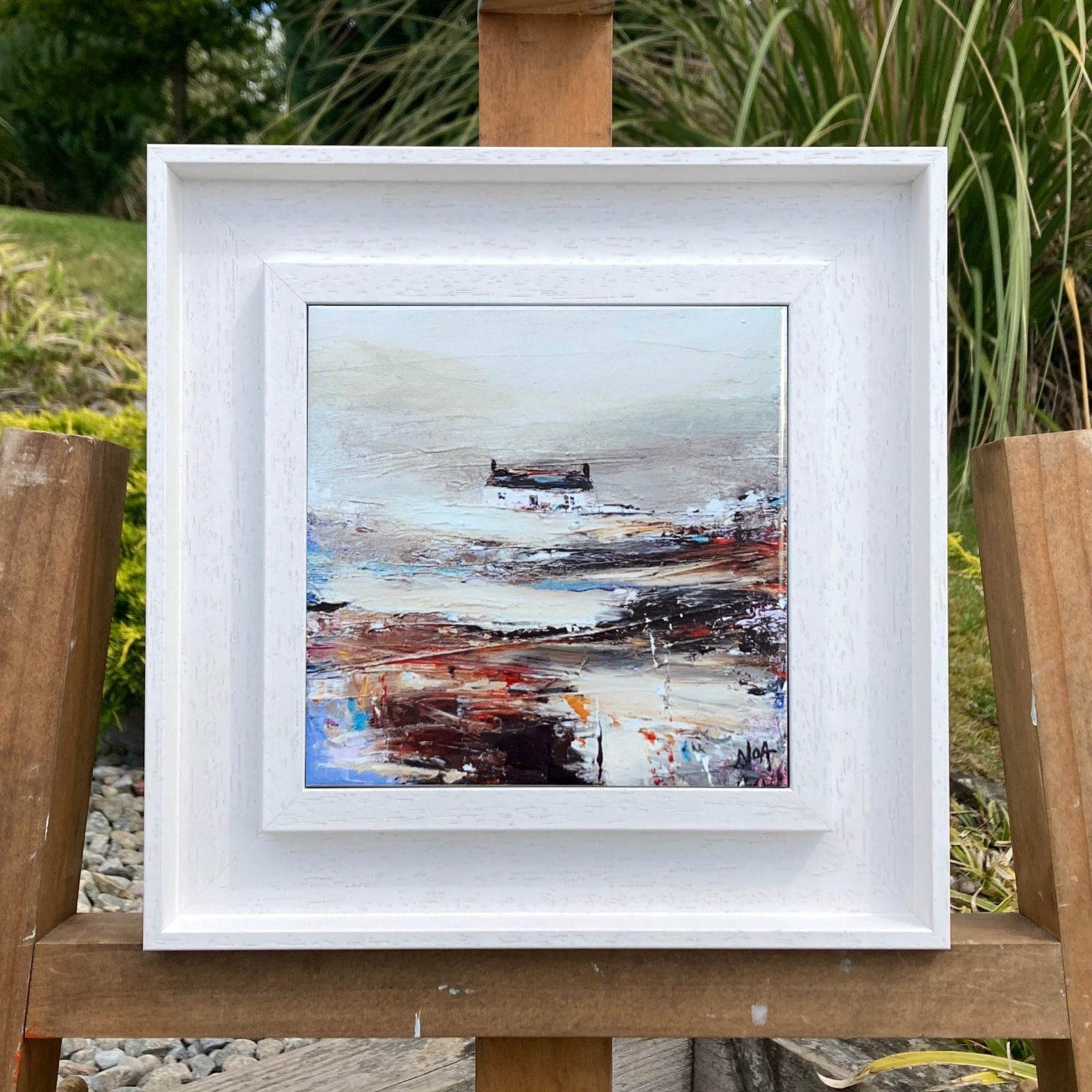 A ceramic tile print of a colourful painting titled 'Rolling Fog', showing a small house nestled in the Scottish Highlands, available mounted on natural slate or framed.