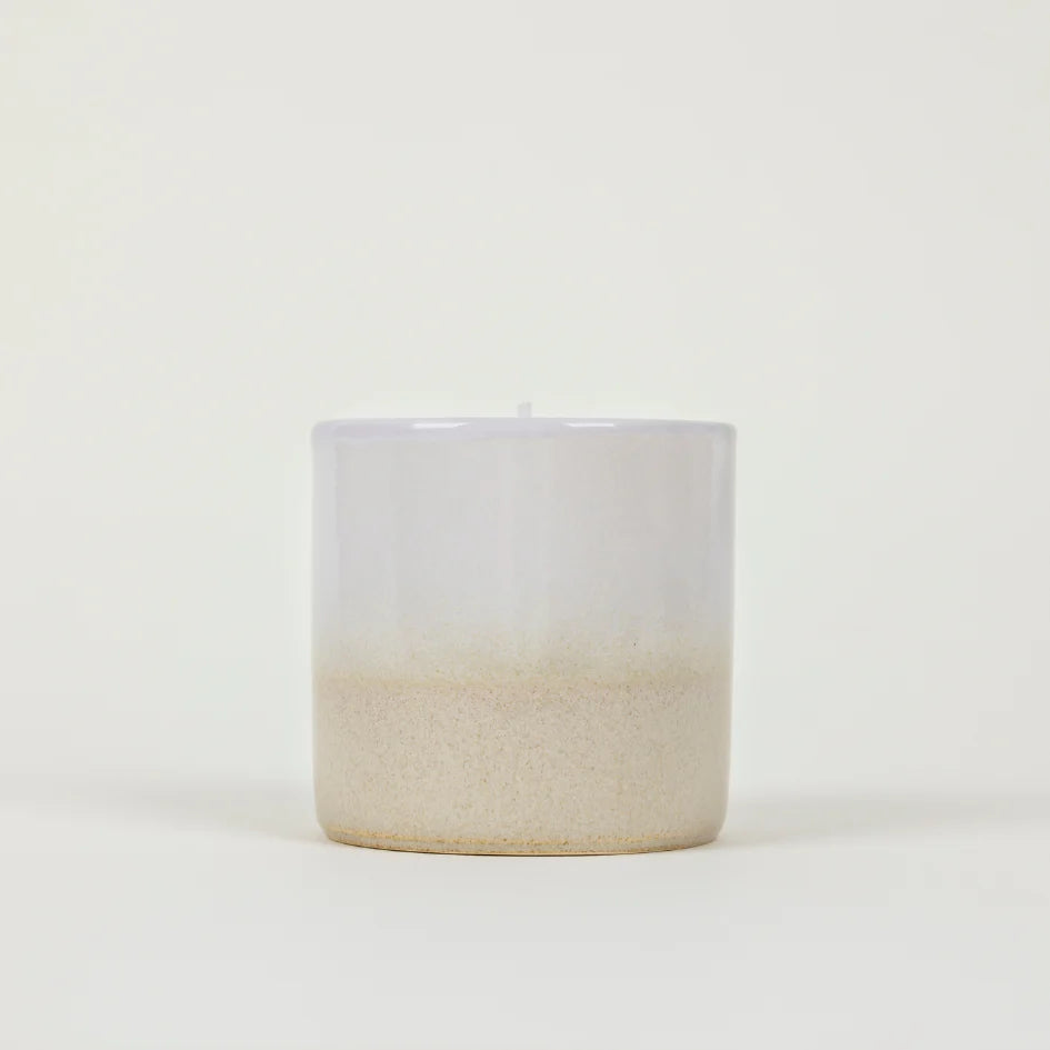 Cream and white St Eval Tranquility ceramic candle on a white background