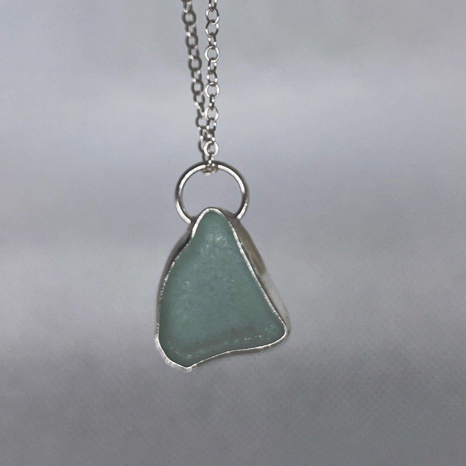 Sterling silver and seafoam green sea glass pendant necklace handmade in Dundee with triangle shape design