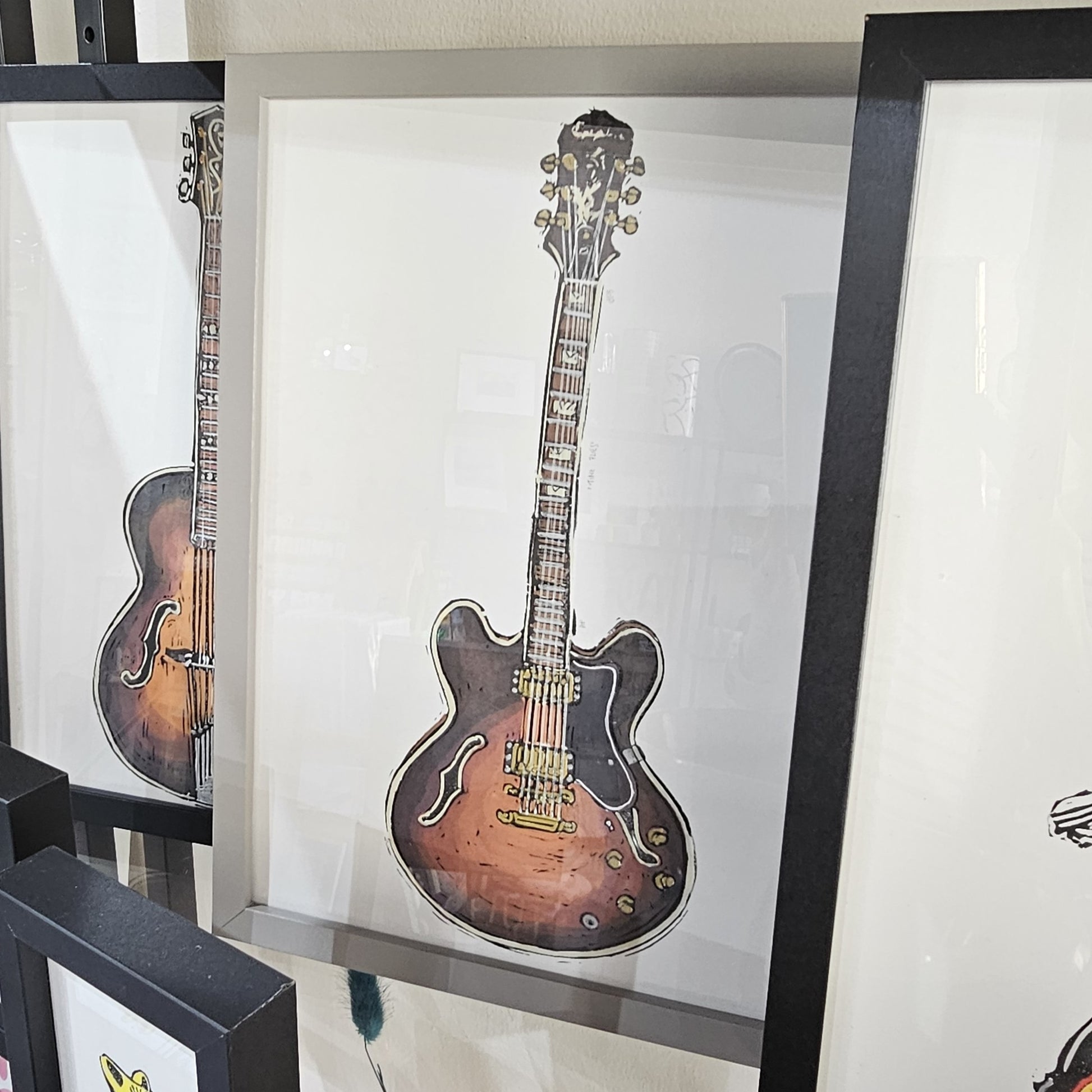 A framed Beebirds artwork print of a Sherton guitar titled 'TIME FLIES'
