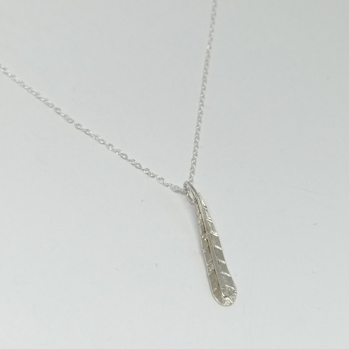 Diana King Jewellery sterling silver single feather pendant necklace with a 30mm feather charm and 18-inch chain, handmade in Perthshire, Scotland.